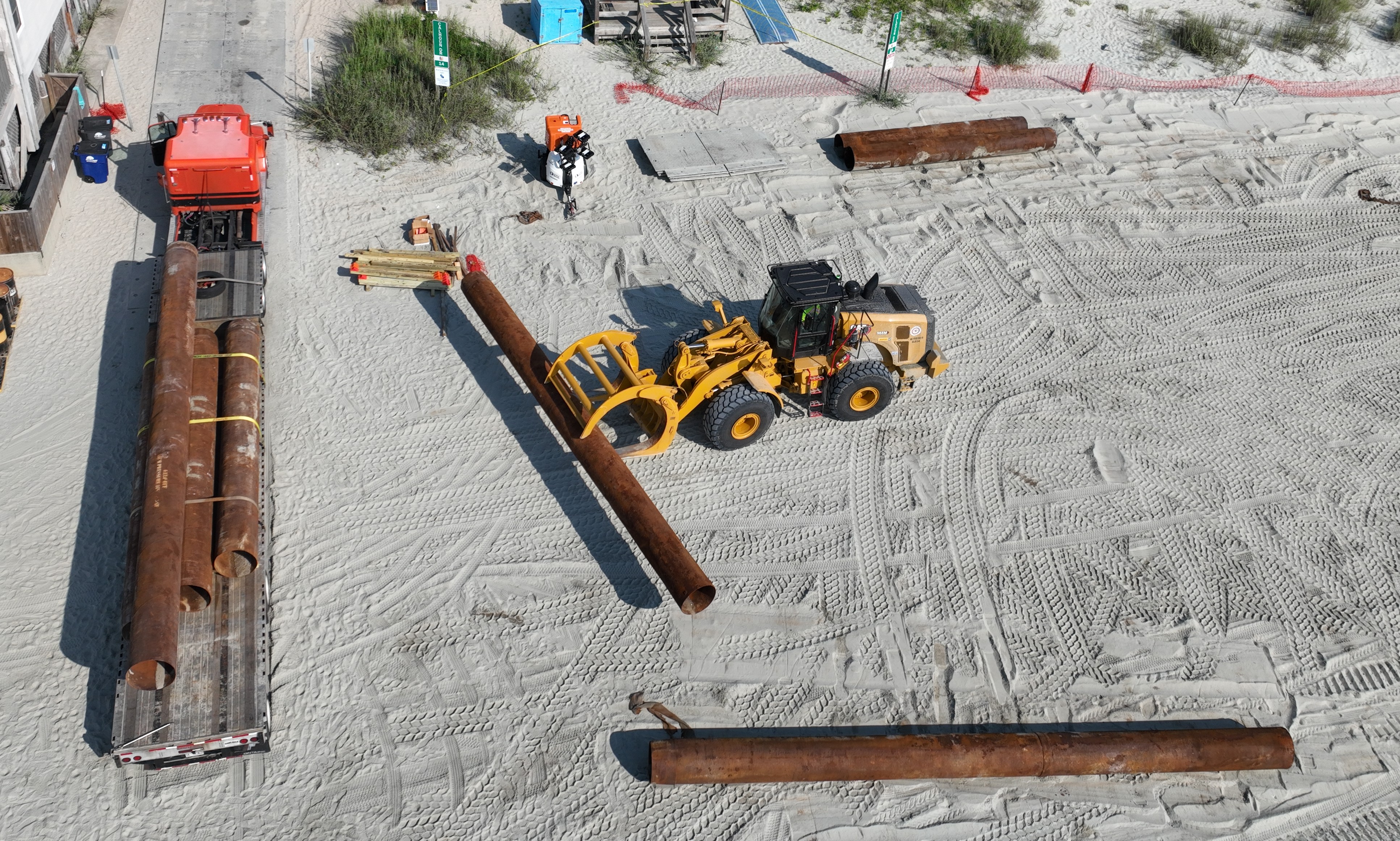 Pipes being loaded onto flatbed truck at Calhoun Drive Beach Access