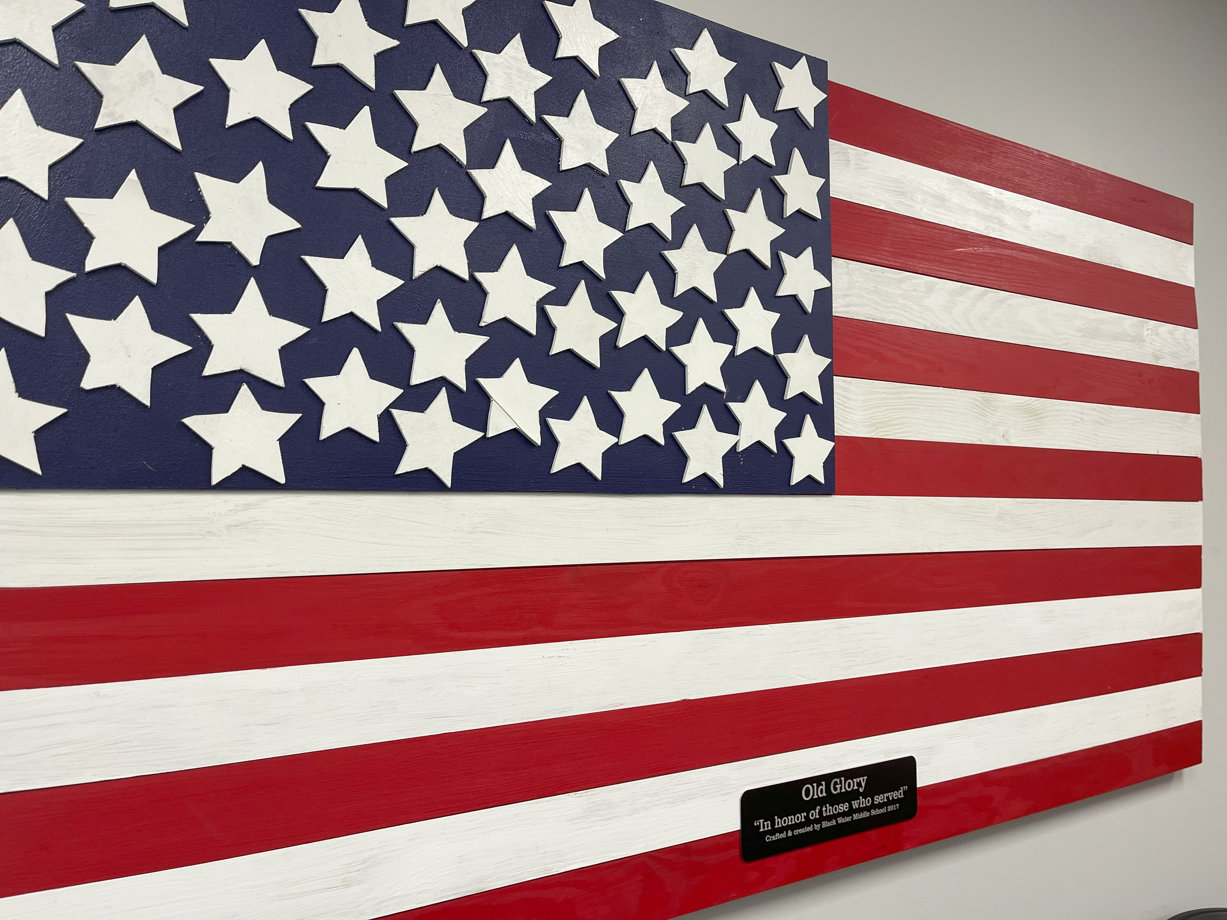 A wooden flag hangs in the lobby of the Horry County Veterans Affairs office.
