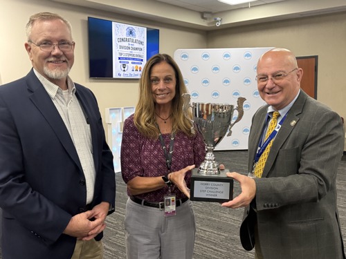 Horry County Assistant Administrator of Infrastructure and Regulation, Horry County Director of Airports and Horry County Administrator pose with Spring Step Challenge Trophy