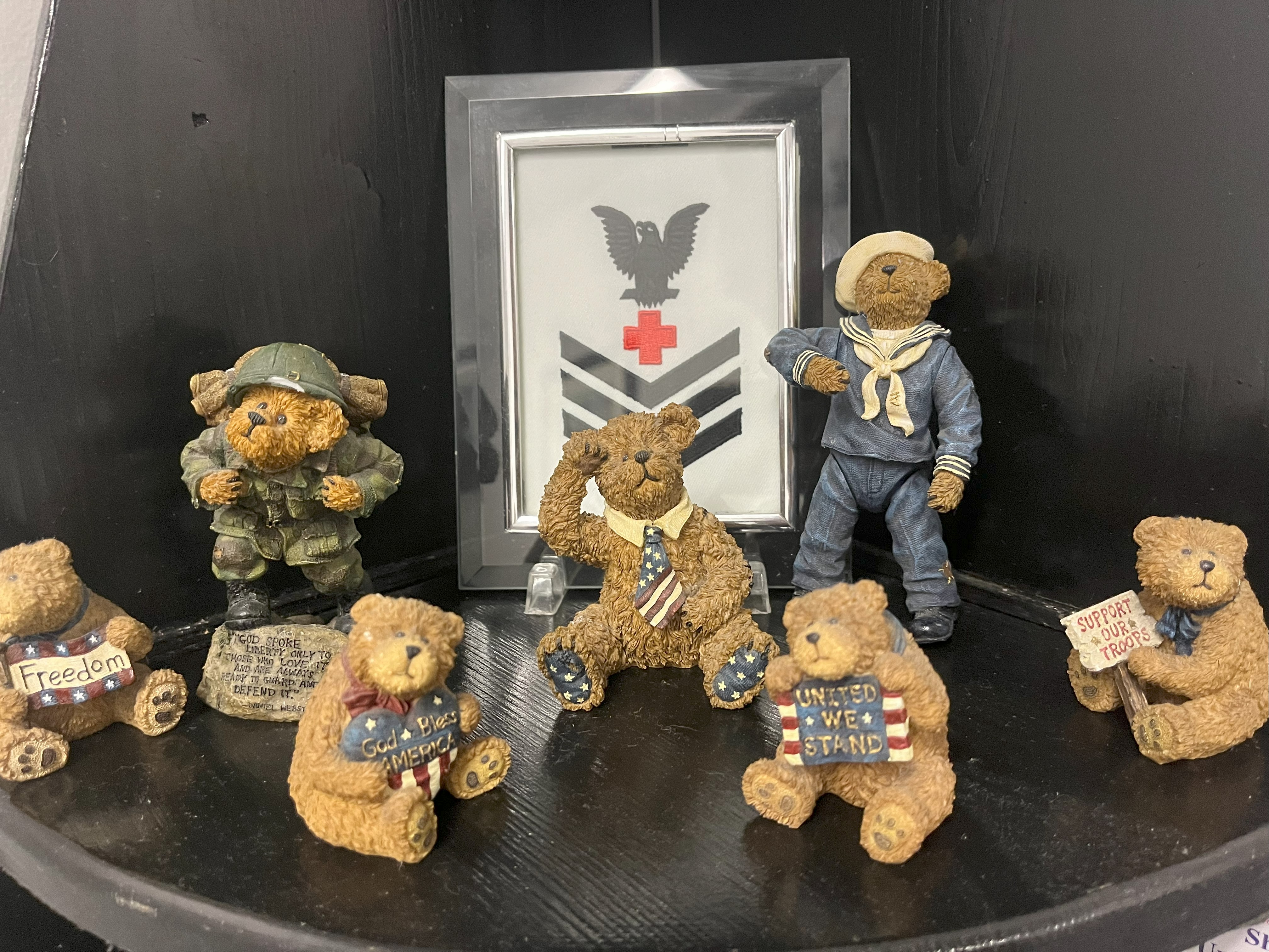 A shelf in Victoria Gore's office holds bear figurines and a framed historic Navy rank insignia. 